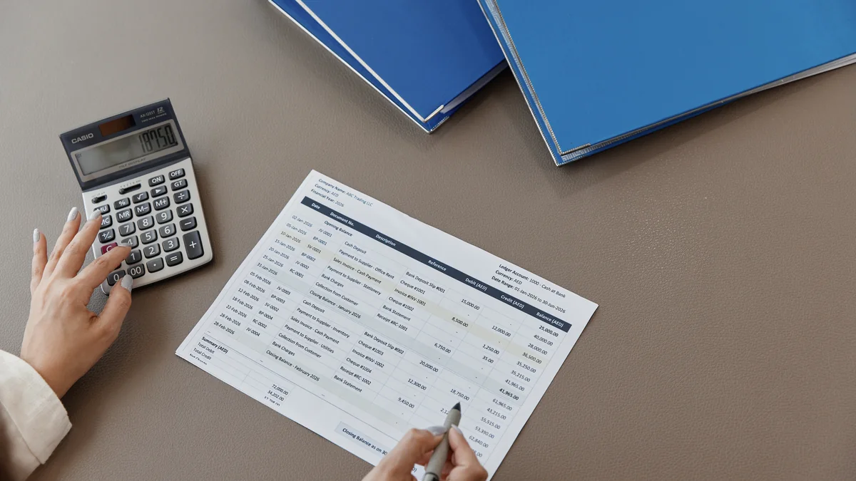 Bookkeeping documents being reviewed at a desk