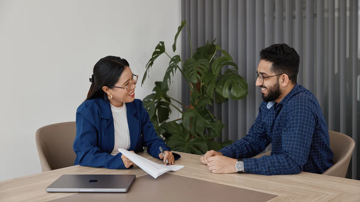 April discussing employee paperwork with a client
